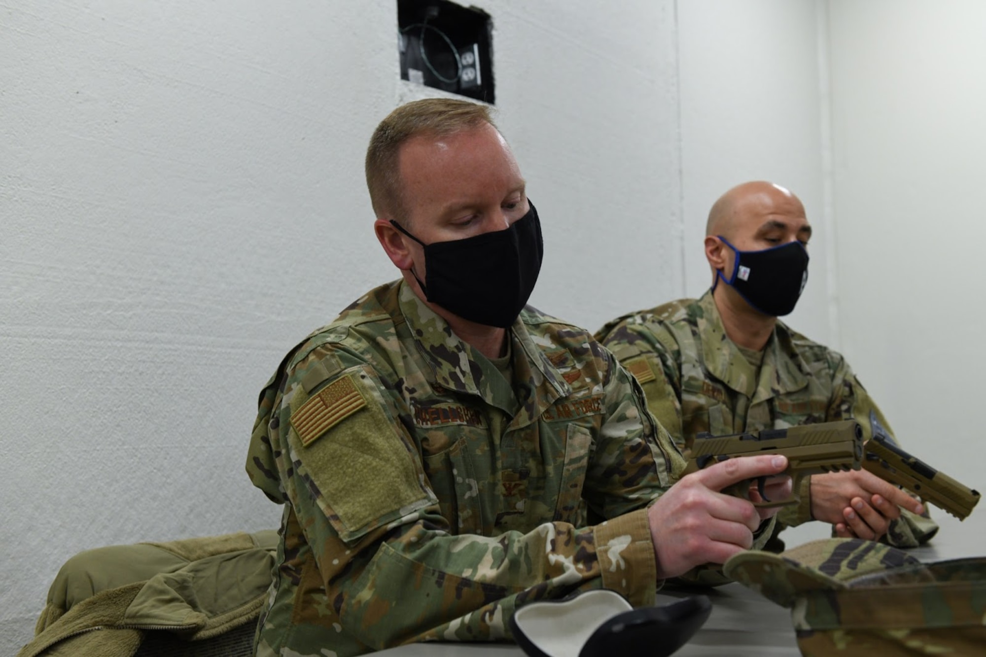 U.S. Air Force Col. Brian Chellgren, acting Buckley Garrison commander, and Chief Master Sgt. Robert Devall, Buckley Garrison command chief, practice operating a firearm as part of a shooting competition at Buckley Air Force Base, Colo., on May 11, 2021. The shooting competition was held by the 460th Security Forces Squadron Combat Arms team as a part of National Police Week. (U.S. Space Force photo by Airman Shaun Combs)