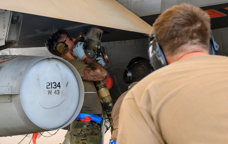 Senior Airman Shane Brennan, 379th Expeditionary Maintenance Squadron C-130 crew chief, performs a “hot pit” refueling, Prince Sultan Air Base, Kingdom of Saudi Arabia, May 3, 2021. Hot pit refueling is where maintainers refuel an aircraft while the engine is still running, allowing the aircraft to safely and quickly return to flying. (U.S. Air Force Photo by Senior Airman Samuel Earick)