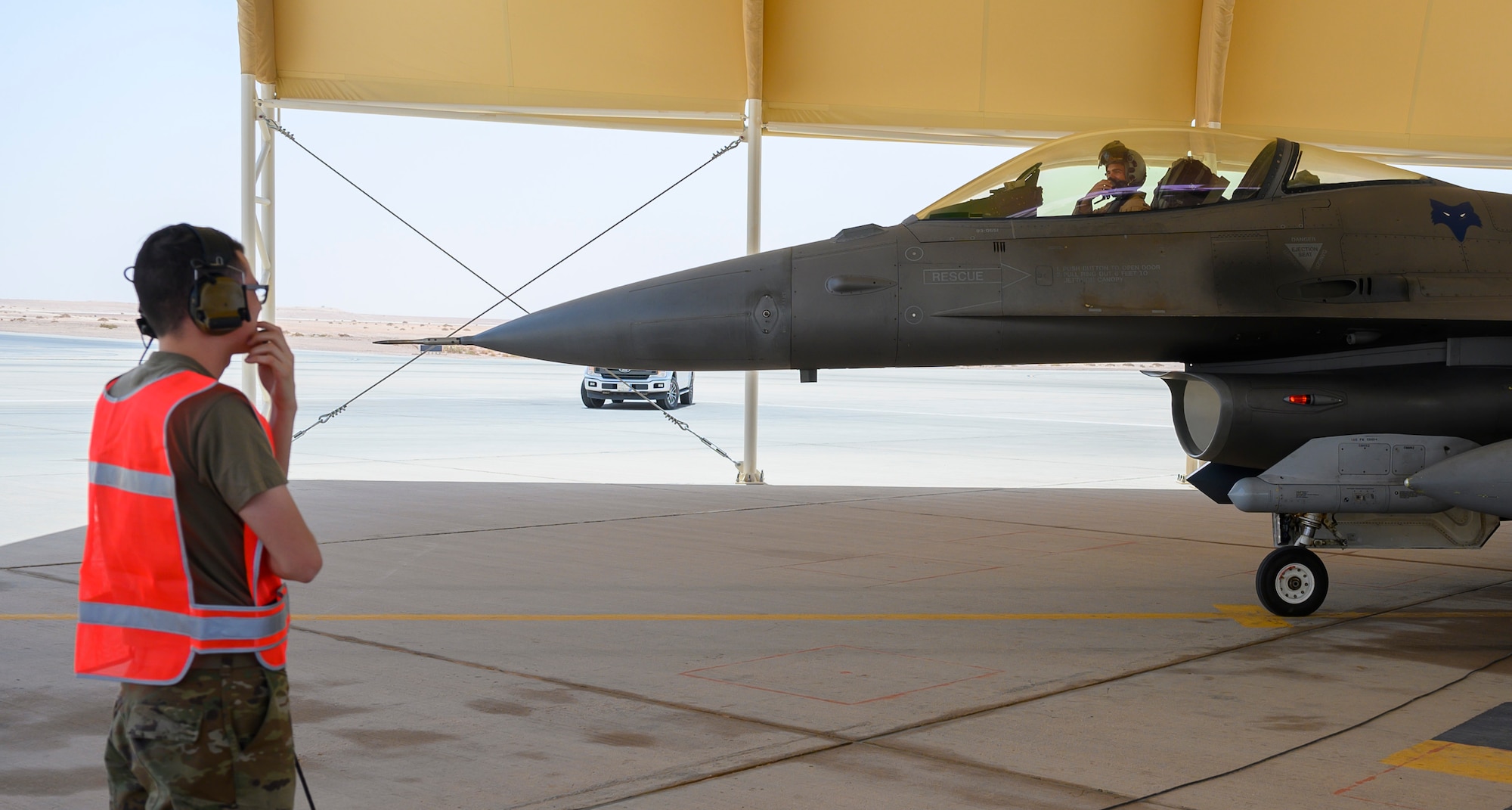 Senior Airman Christopher Adkins, 379th Expeditionary Maintenance Squadron B-1 crew chief, talks to a pilot, 157th Expeditionary Fighter Squadron, during “hot pit” training, Prince Sultan Air Base, Kingdom of Saudi Arabia, May 3, 2021. Hot pit refueling is where maintainers refuel an aircraft while the engine is still running, allowing the aircraft to safely and quickly return to flying. (U.S. Air Force Photo by Senior Airman Samuel Earick)
