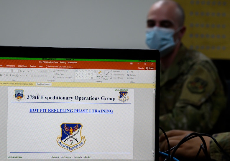 Senior Airman Scott Fure, 379th Expeditionary Maintenance Squadron C-130 crew chief, listens to an instructor during the classroom portion of “hot pit” refueling training, Prince Sultan Air Base, Kingdom of Saudi Arabia, April 28, 2021. Hot pit refueling is where maintainers refuel an aircraft while the engine is still running, allowing the aircraft to safely and quickly return to flying. (U.S. Air Force Photo by Senior Airman Samuel Earick)