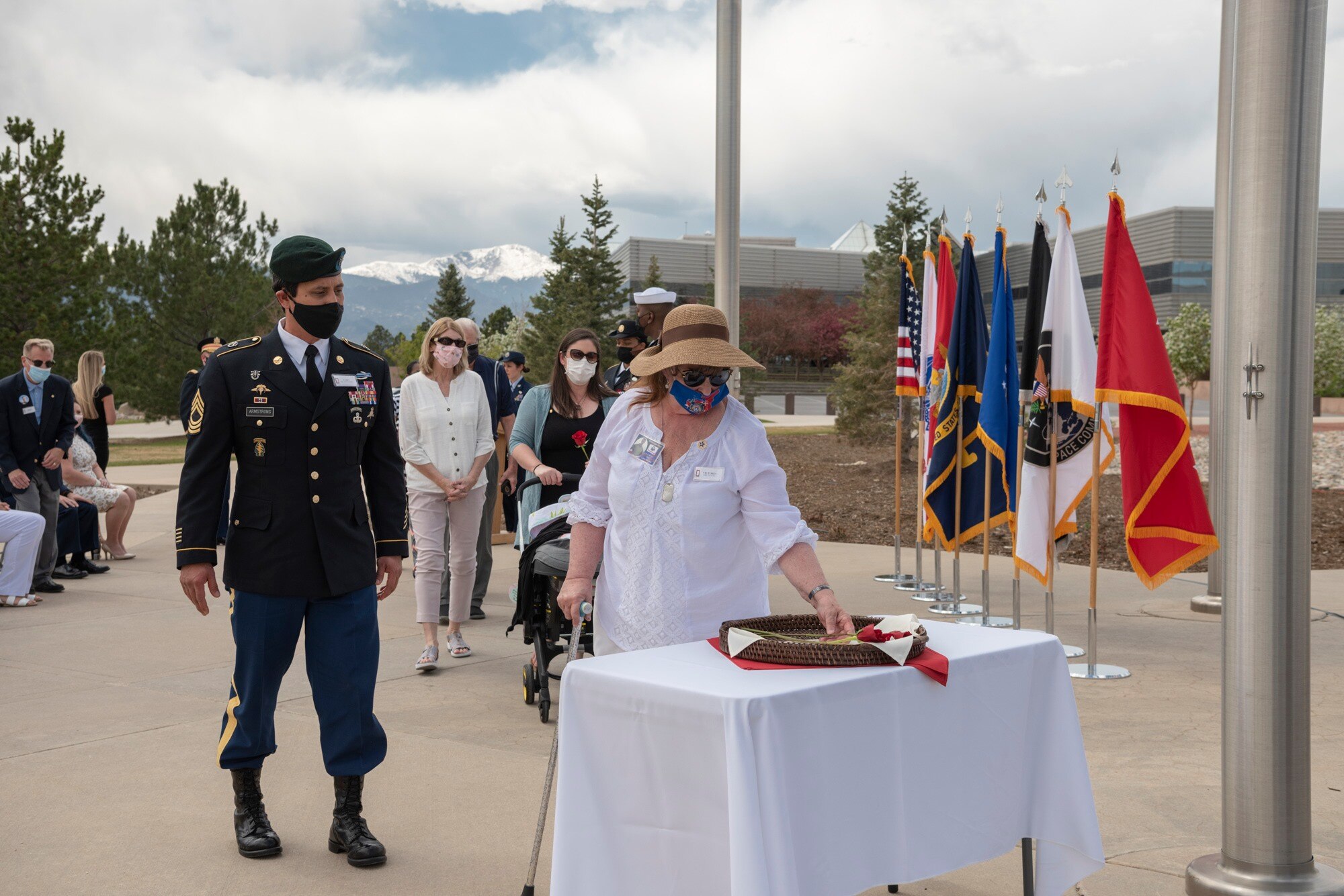 Gold Star families from Colorado’s Front Range place remembrance roses at the base of the flagpole May 7 during a Gold Star flag raising ceremony at Peterson Air Force Base, Colorado. Each rose represented a fallen service member.