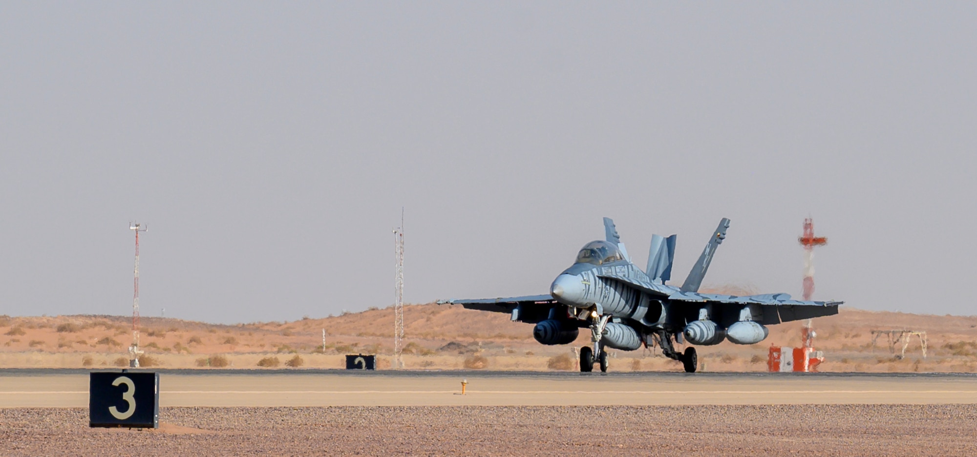 A U.S. Marine Corps F/A-18D Hornet lands on the flightline at Prince Sultan Air Base, Kingdom of Saudi Arabia, May 8, 2021. Personnel, aircraft, and supplies from Marine All Weather Fighter Attack Squadron 224, Marine Aircraft Group 31, deployed to PSAB from Marine Corps Air Station Beaufort, South Carolina, as part of a dynamic force employment to enhance U.S. Central Command’s ability to deter aggression and promote security and stability within the USCENTCOM area of responsibility. (U.S. Air Force photo by Senior Airman Samuel Earick)