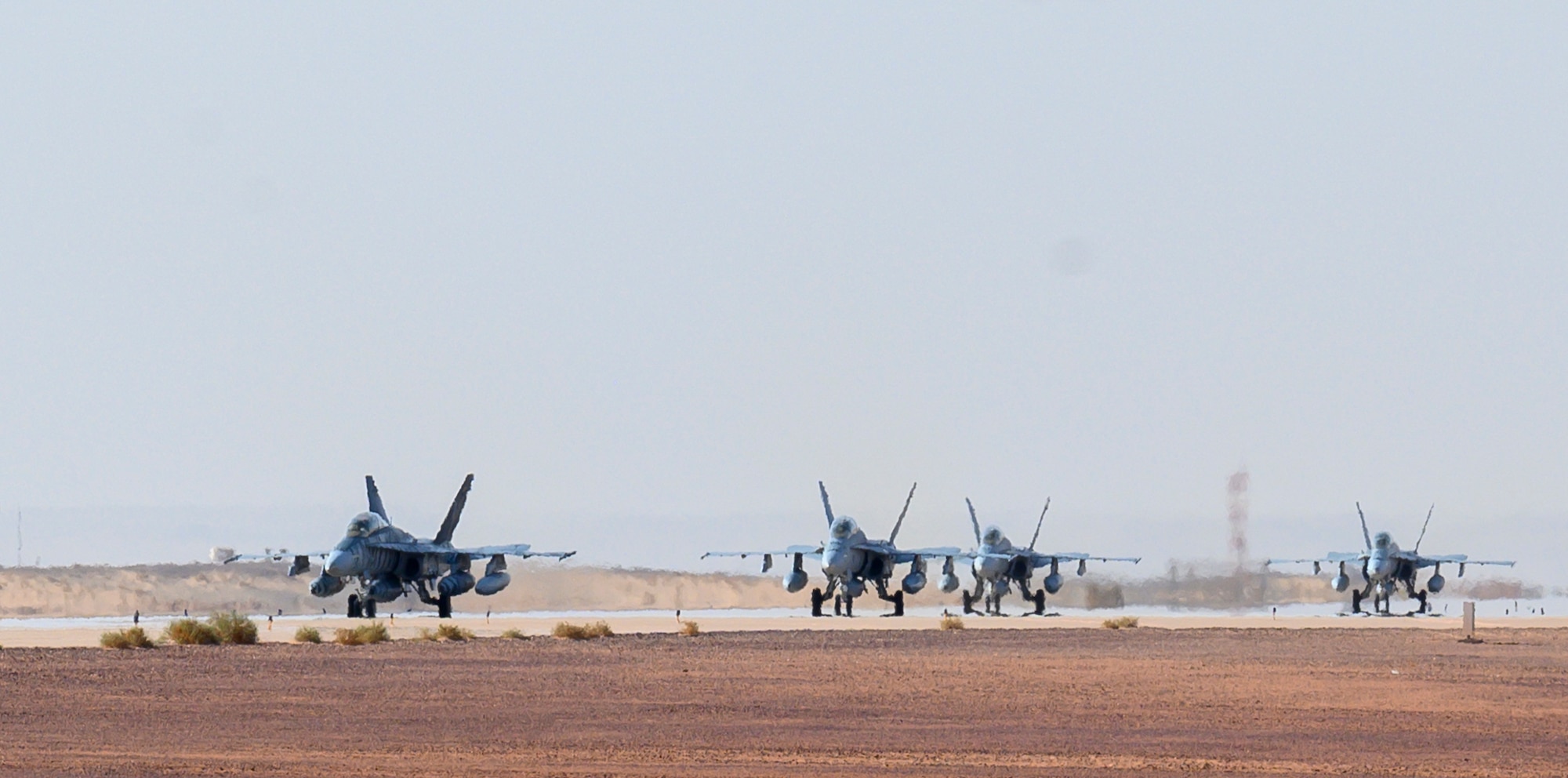 U.S. Marine Corps F/A-18D Hornets taxi across the flightline at Prince Sultan Air Base, Kingdom of Saudi Arabia, May 8, 2021. A detachment of F/A-18s, along with squadron personnel from Marine Corps Air Station Beaufort, South Carolina, will rapidly integrate into theater training, as well as joint and partnered missions, as part of a dynamic force employment highlighting the U.S. military’s ability to rapidly deploy and employ forces anywhere around the globe. (U.S. Air Force photo by Senior Airman Samuel Earick)