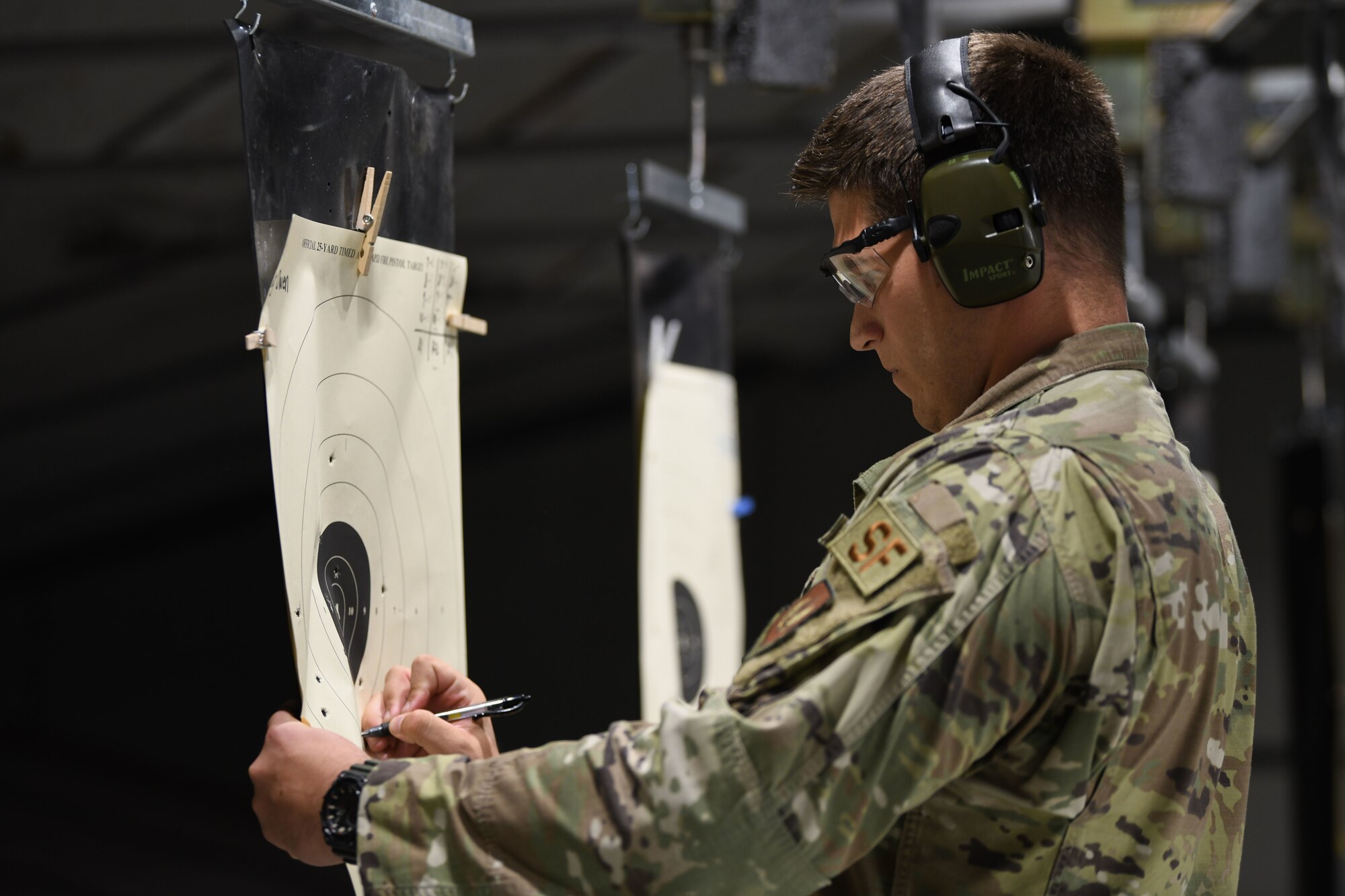 Tech. Sgt. Dustin Silc, 31st Security Forces Squadron (SFS) member, scores a target paper at Aviano Air Base, Italy, May 12, 2021. Airmen from the 31st Fighter Wing participated in an “Excellence Competition” during Police Week. Police Week recognizes the service and sacrifice of U.S. law enforcement members, paying special tribute to those who have lost their lives in the line of duty for the safety and protection of others. (U.S. Air Force photo by Senior Airman Ericka A. Woolever)