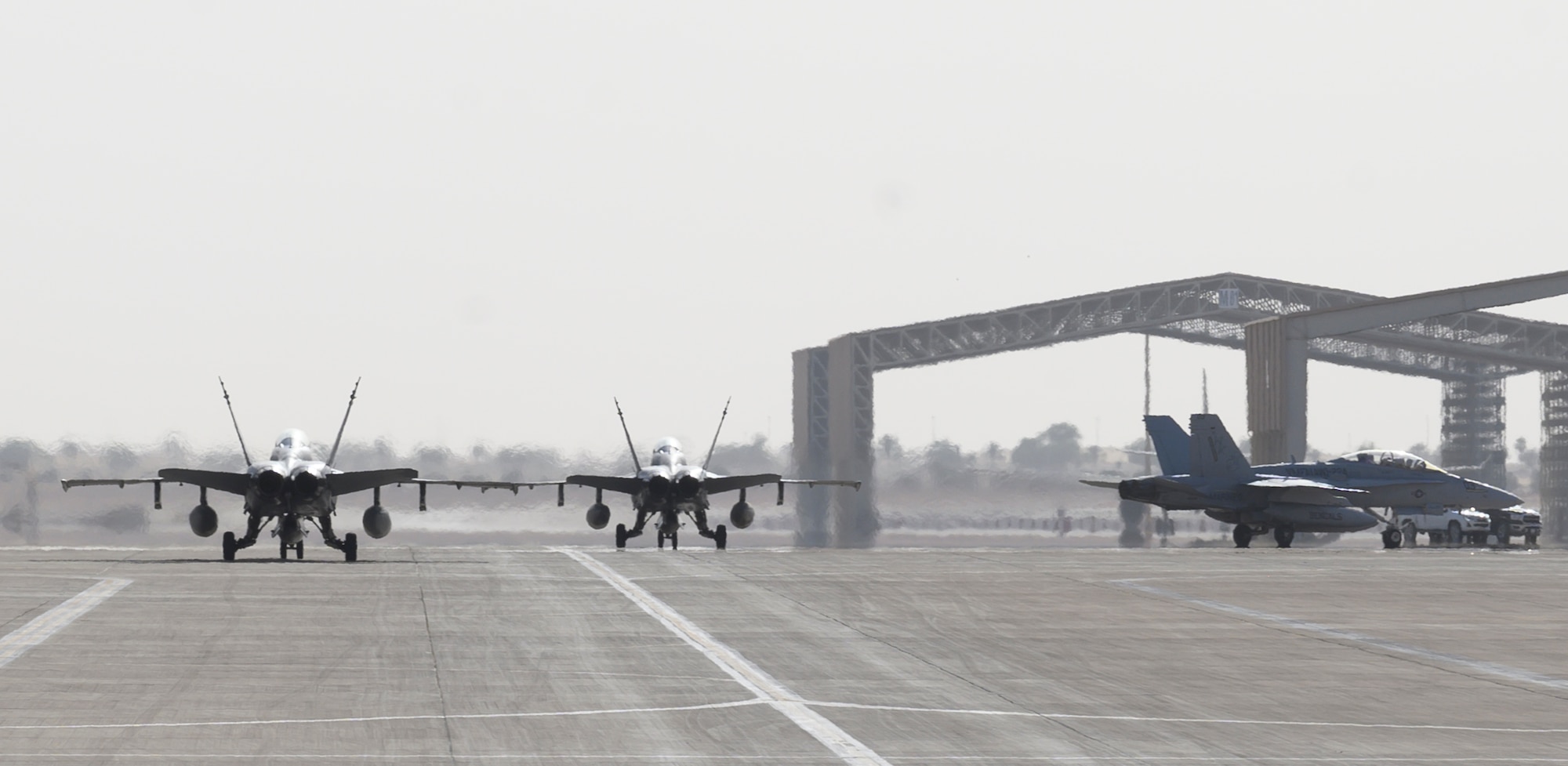 U.S. Marine Corps F/A-18D Hornets taxi to their parking spots at Prince Sultan Air Base, Kingdom of Saudi Arabia, May 8, 2021. A detachment of F/A-18s, along with squadron personnel from Marine Corps Air Station Beaufort, South Carolina, will rapidly integrate into theater training, as well as joint and partnered missions, as part of a dynamic force employment highlighting the U.S. military’s ability to rapidly deploy and employ forces anywhere around the globe.  (U.S. Air Force photo by Senior Airman Samuel Earick)