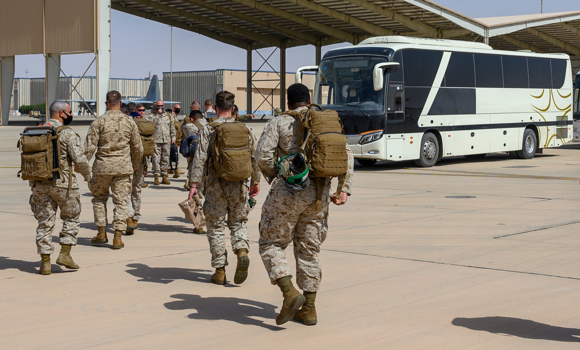 Members of Marine All Weather Fighter Attack Squadron 224, Marine Aircraft Group 31, load onto a bus after arriving at Prince Sultan Air Base, Kingdom of Saudi Arabia, May 8, 2021. Personnel, aircraft, and supplies from Marine All Weather Fighter Attack Squadron 224, Marine Aircraft Group 31, deployed to PSAB from Marine Corps Air Station Beaufort, South Carolina as part of a dynamic force employment to enhance U.S. Central Command’s ability to deter aggression and promote security and stability within the USCENTOM area of responsibility. (U.S. Air Force photo by Senior Airman Samuel Earick)