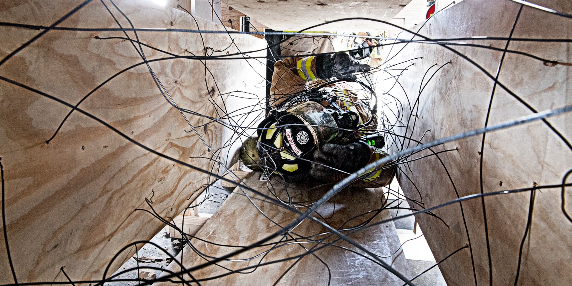 Firefighters attending the rescue and survival course at Grissom May 10-14 had to work their way through an entrapment exercise wearing their bunker gear. Firefighters from six different departments gathered here for an intense week of training. (Air Force photo by Douglas Hays)