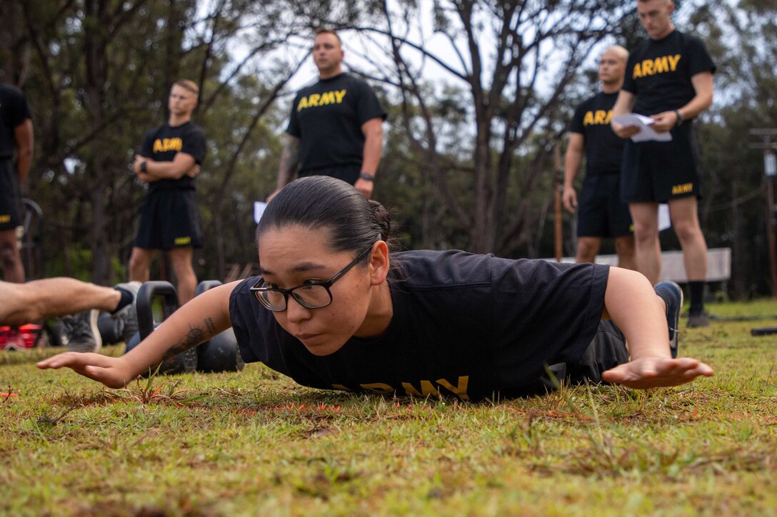 A soldier lies on her stomach.