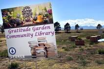 A photo of the Schriever community garden and library sign