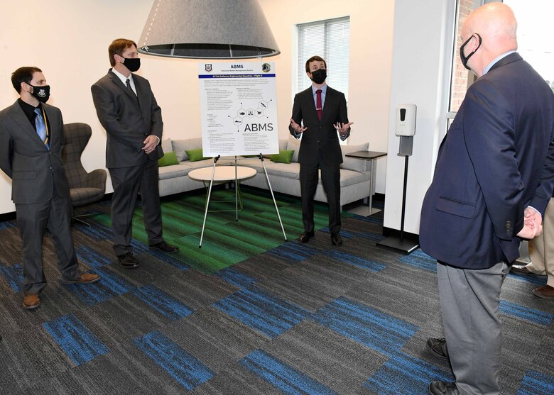 Acting Secretary of the Air Force John Roth is briefed by Derek Cook, 577th Software Engineering Squadron team lead, at the Project Synergy facility in Warner Robins, Ga., May 10, 2021. Project Synergy, a collaborative effort between the Warner Robins Air Logistics Complex and the Houston County Board of Education, was established in response to the growing software workloads within the Air Force and the need for space currently unavailable at Robins Air Force Base.