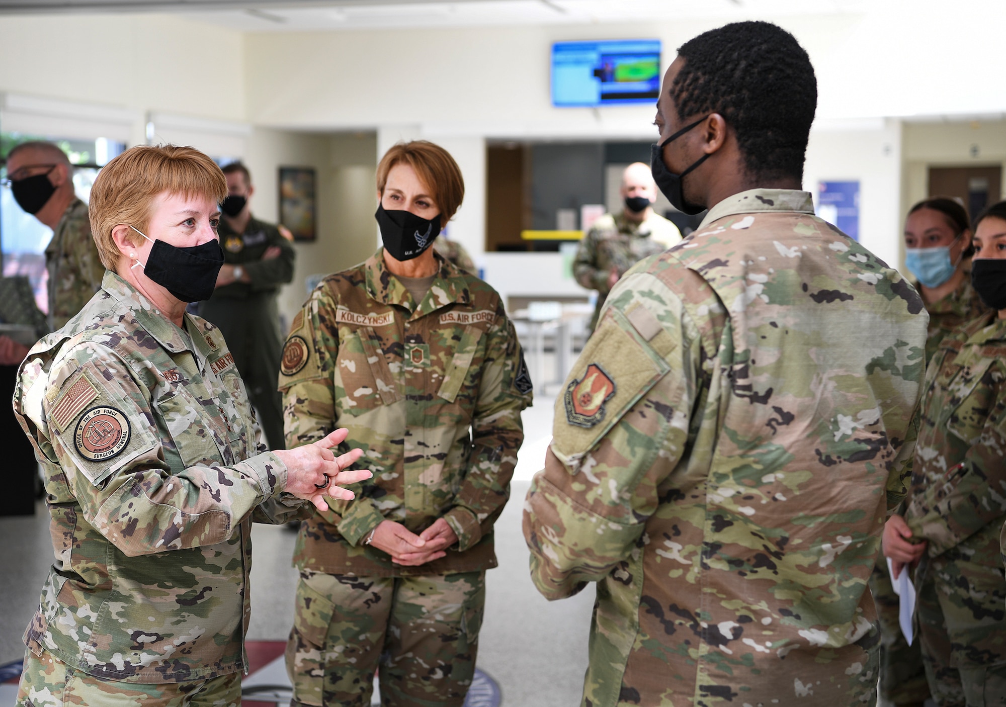 Air Force Surgeon General Lt. Gen. Dorothy Hogg speaks to Senior Airman Seafah Kollie, 66th Medical Squadron Radiology technician, during a visit to the clinic at Hanscom Air Force Base, Mass., May 11, as Chief Master Sgt. Dawn Kolczynski, chief of the Medical Enlisted Force, looks on. Hogg met with Airmen and recognized their contributions to the health and wellness of the community throughout COVID-19. (U.S. Air Force photo by Lauren Russell)