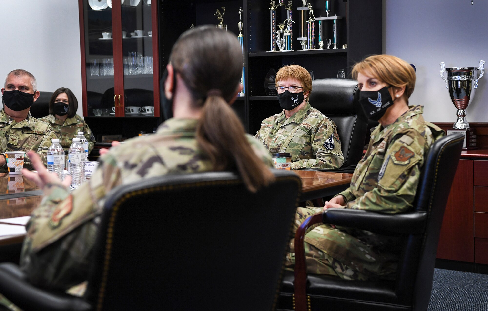 Air Force Surgeon General Lt. Gen. Dorothy Hogg, center, and Chief Master Sgt. Dawn Kolczynski, right, chief of the Medical Enlisted Force, listen to a mission brief by Chief Master Sgt. Holly Burke, 66th Medical Squadron superintendent, during a visit to Hanscom Air Force Base, Mass., May 11. During their visit, Hogg and Kolczynski met with members of the Hanscom clinic and recognized the positive impacts they have made through the pandemic. (U.S. Air Force photo by Lauren Russell)