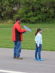 Earle B. Wood Middle School technology teacher John Lee and his daughter prepare to fly a rubber-powered, free-flight airplane at Davis Airfield in Laytonsville, Md., on April 25, 2021. The after school STEM club, also known as the Marauding Mustangs, were competing in this year’s International Postal Contest.