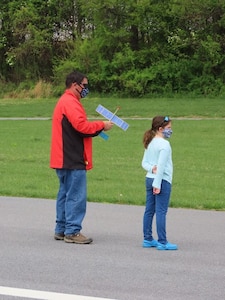 Earle B. Wood Middle School technology teacher John Lee and his daughter prepare to fly a rubber-powered, free-flight airplane at Davis Airfield in Laytonsville, Md., on April 25, 2021.