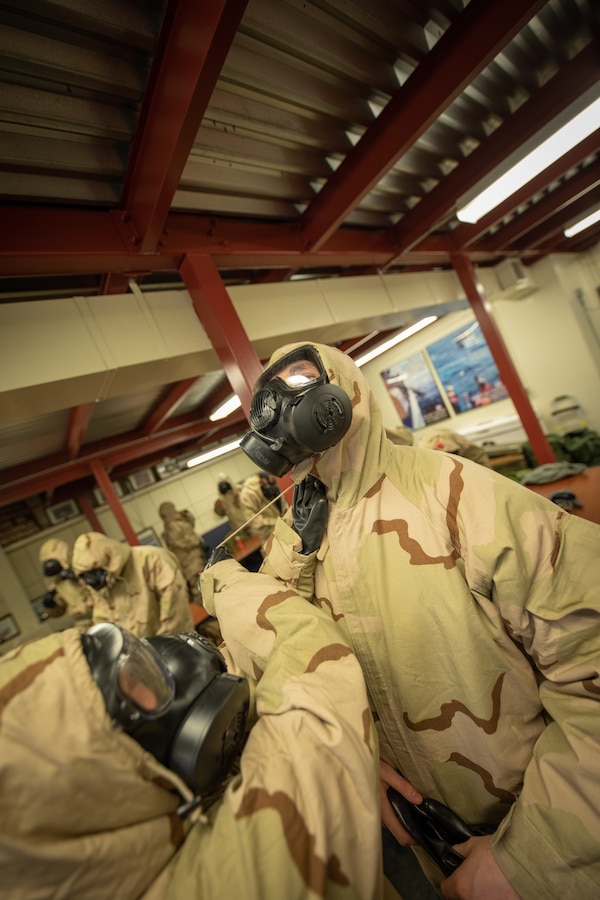 U.S. Marines don Mission Oriented Protective Posture (MOPP) gear for Chemical, Biological, Radiological, and Nuclear (CBRN) defense training during Arctic Care 2021 in Kodiak, Alaska, on May 7, 2021. Arctic Care 2021 is a joint-service training mission led by the United States Air Force and supported by members of the Air National Guard, Marines, Marine Reserves, Navy, Navy Reserves, National Guard, and Army Reserves. (U.S. Marine Corps photo by Lance Cpl. James Stanfield)