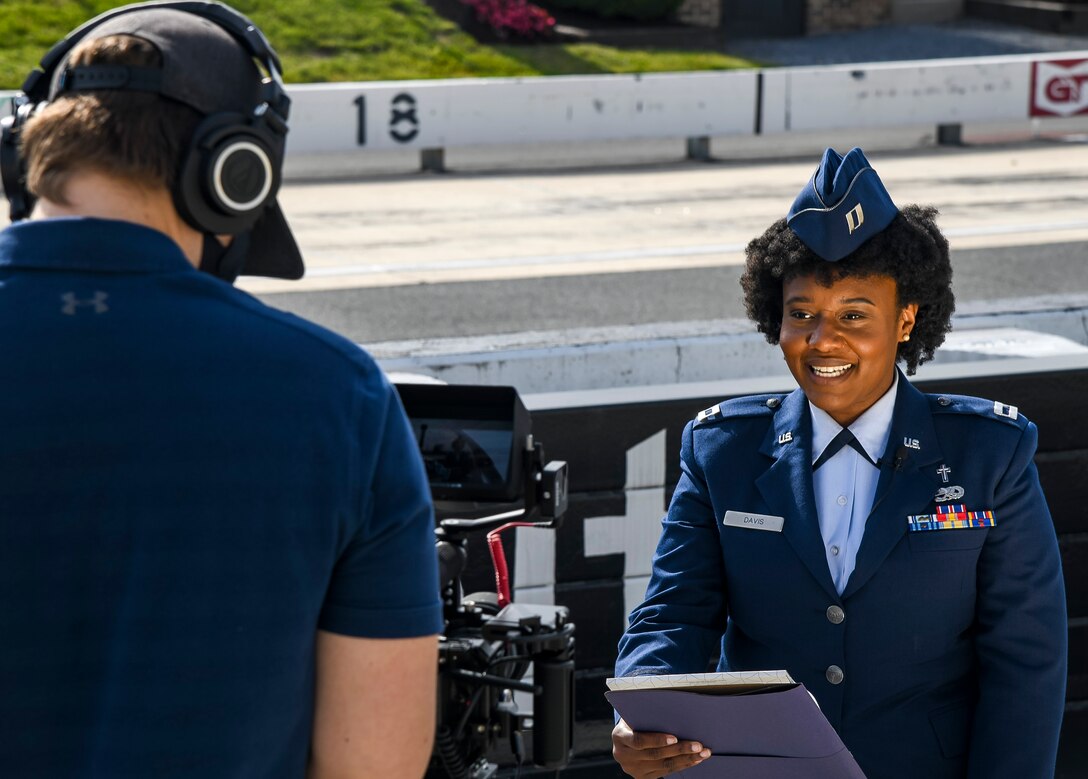 Capt. Megan Davis, 512th Airlift Wing chaplain, leads a prayer at Dover International Speedway, Delaware, May 6, 2021. Service members prerecorded the singing of the national anthemand invocation to air during the races and on television for the upcoming NASCAR event. (U.S. Air Force photo by Airman 1st Class Stephani Barge)