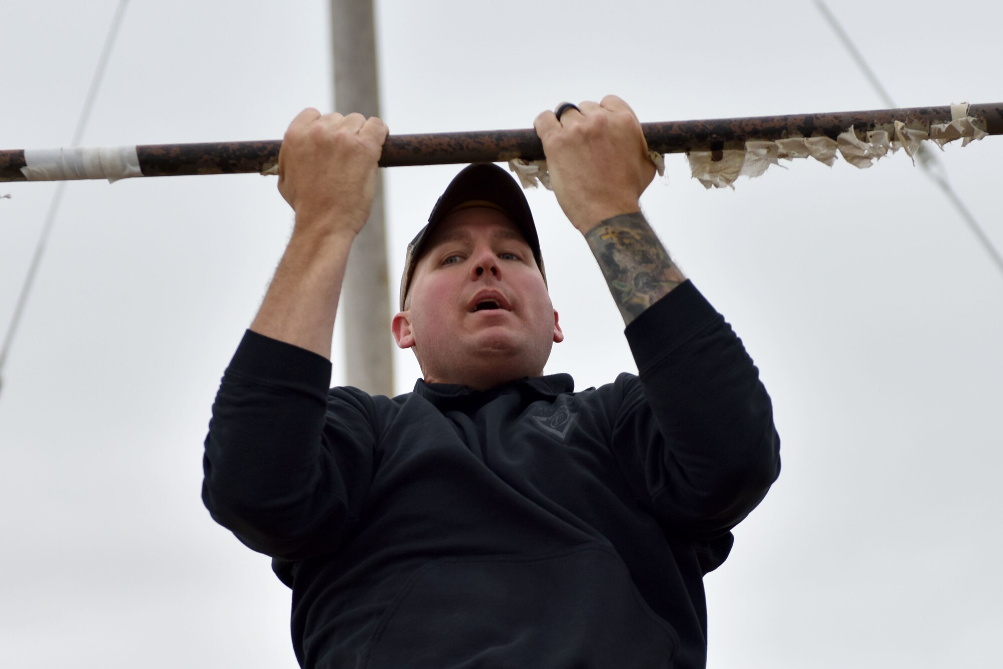 U.S. Air Force Master Sgt. Mark Karas, 17th Security Forces Squadron flight chief, completes a pull up during the National Police Week obstacle course on Goodfellow Air Force Base, Texas, May 12, 2021. The top five competitors of the event won a Police Week themed patch. (U.S. Air Force photo by Staff Sgt. Seraiah Wolf)