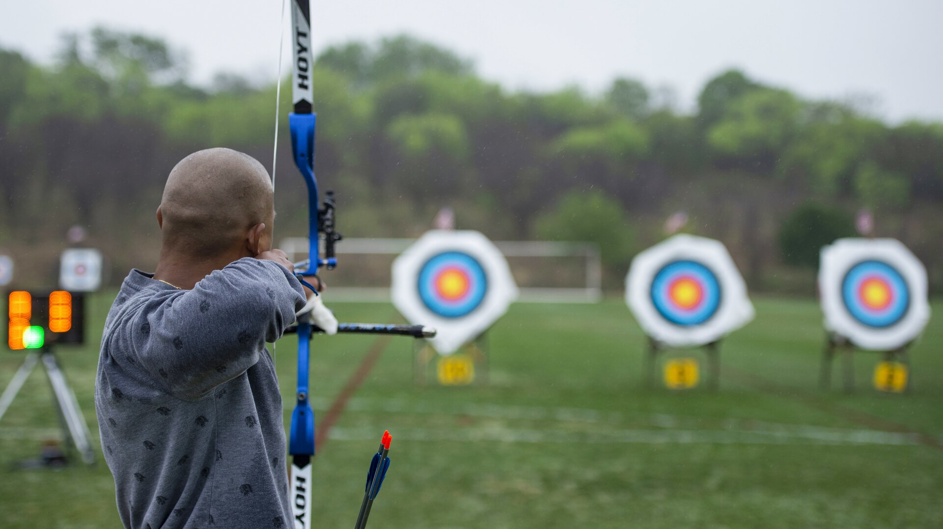 Man prepares to shoot arrow at target