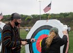 Man pulling arrow from target