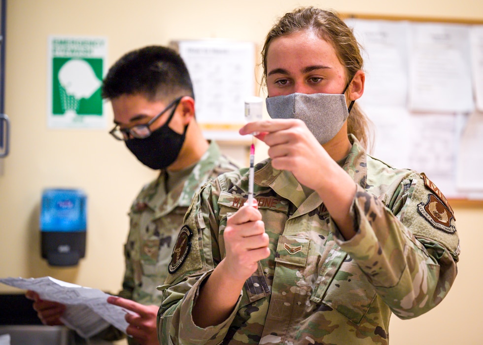 an airman prepares a vaccine