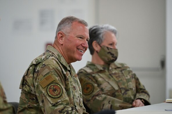 Man laughs while seated.