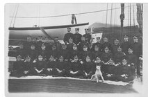 A photo of officers and mascots aboard Revenue Cutter Perry