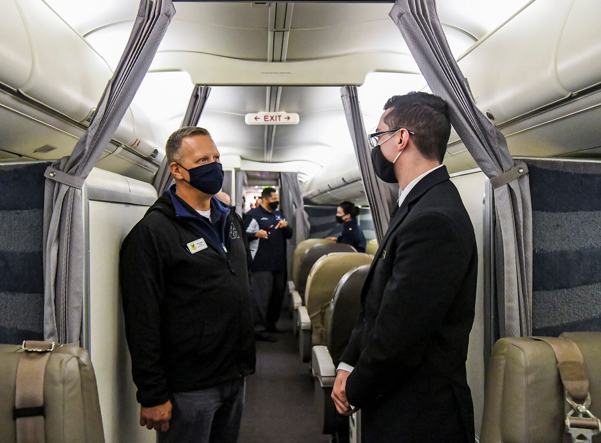 Don Chupp, Dover Air Force Base honorary commander, speaks with a 89th Airlift Wing flight attendant inside a C-32A aircraft during an honorary commander tour at Joint Base Andrews, Maryland, May 10, 2021. Flight attendants ensure the safety and comfort of traveling U.S. leaders and are responsible for planning, coordinating and managing cabin duties. (U.S. Air Force photo by Airman 1st Class Stephani Barge)