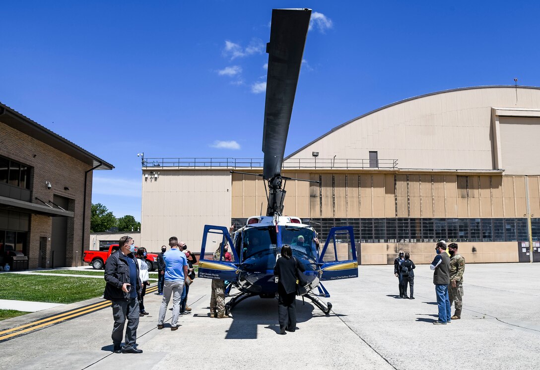 Dover Air Force Base honorary commanders tour a UH-1N “Huey” from the 1st Helicopter Squadron during a visit to Joint Base Andrews, Maryland, May 10, 2021. The UH-1N is a light-lift utility helicopter used to support various missions which include airlift of emergency security forces, security and surveillance of off-base nuclear weapons convoys, and distinguished visitor airlift. (U.S. Air Force photo by Airman 1st Class Stephani Barge)