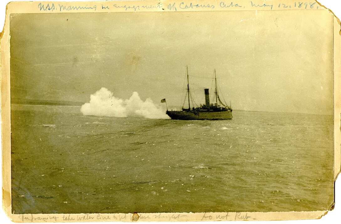 A photo of the Revenue Cutter Manning firing at Spanish positions on Cabanas, Cuba in 1898.