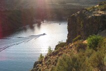 A boat navigates its way across Lucky Peak Lake