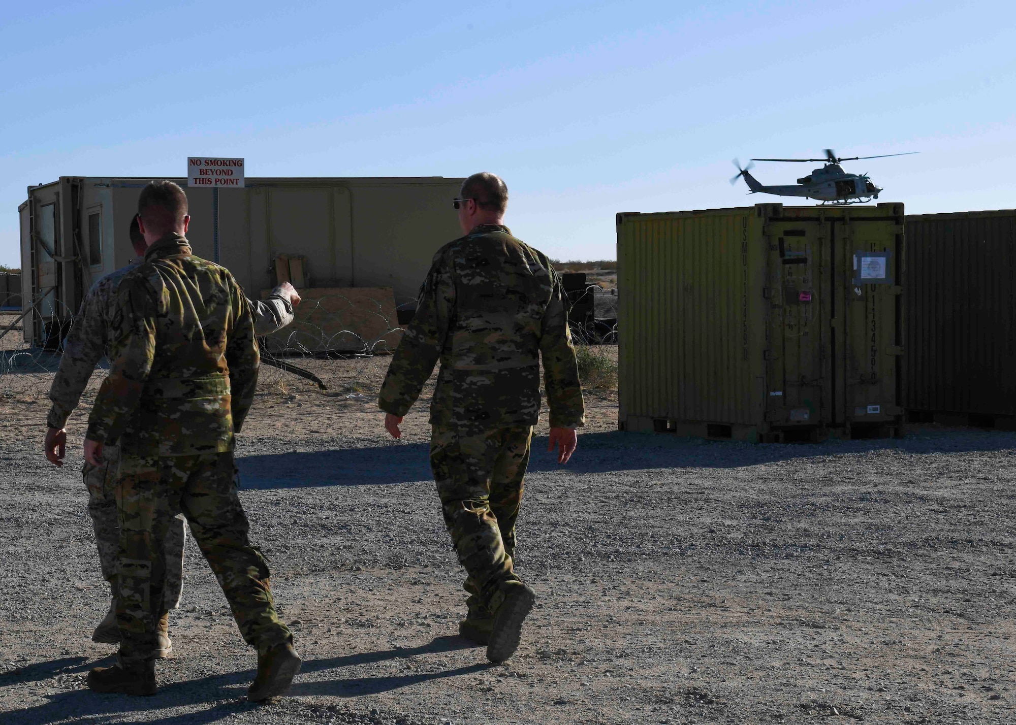 U.S. Air Force Airmen from the 384th and 93rd Air Refueling Squadrons walk towards an airfield during an observation of a Marine Corps exercise on Marine Corps Air Ground Combat Center, California, May 4, 2021. The observation allowed Team Fairchild the opportunity to create a joint partnership between Airmen and Marines for future exercises. (U.S. Air Force photo by Airman 1st Class Kiaundra Miller)