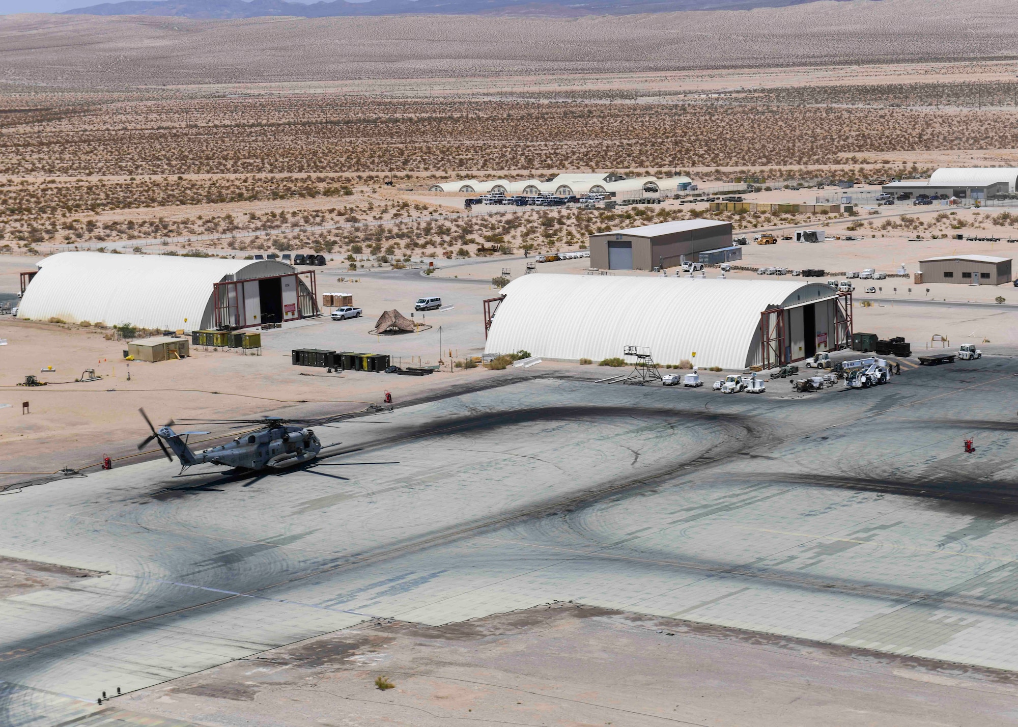 A civilian helicopter pilot flies a Mil Mi-17 helicopter over Marine Corps Air Ground Combat Center, California, May 6, 2021. The Marines involved in the exercise were split into two grounds, one representing friendly forces and the other representing enemy forces. The Mi-17 helicopter was in charge of flying over forces and simulating air attacks on either the friendly or enemy side of the team. (U.S. Air Force photo by Airman 1st Class Kiaundra Miller)