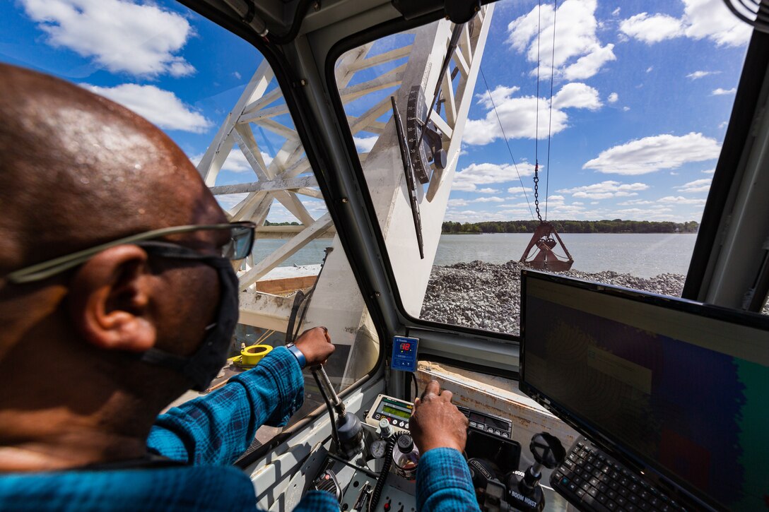 Clarence Hinton, a crane operator, maneuvers  picks up rock to place in the Tred Avon River Oyster Sanctuary in Talbot County, Maryland May 6, 2021. The U.S. Army Corps of Engineers, Baltimore District, along with federal and non-federal partners resumed construction of the oyster reefs in April and approximately 34 acres of reef will be restored when the work is completed. (USACE photo by Christopher