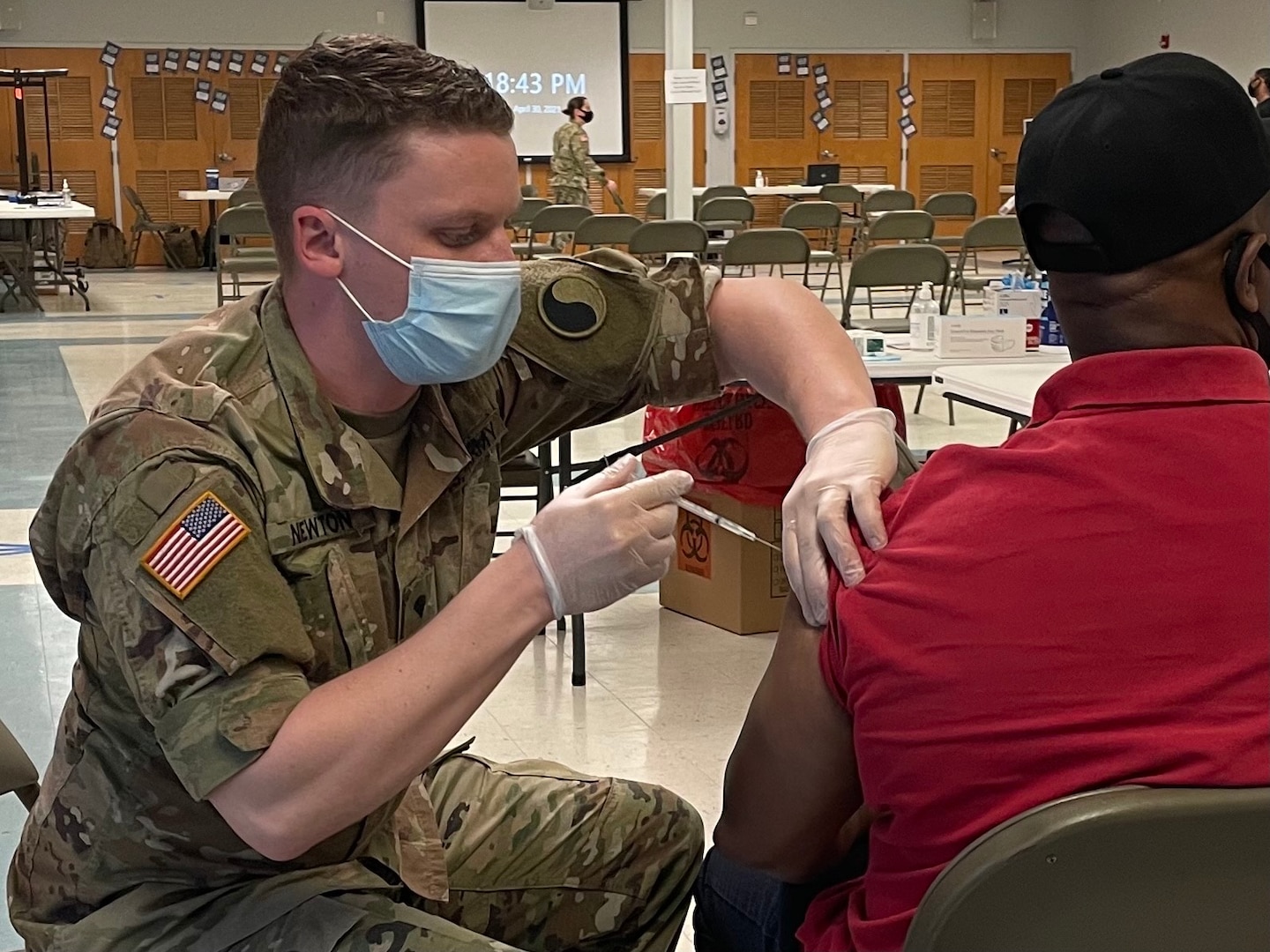 A Virginia National Guard Soldier administers a COVID-19 vaccine to a citizen during a mobile vaccination clinic in Norfolk, Virginia.