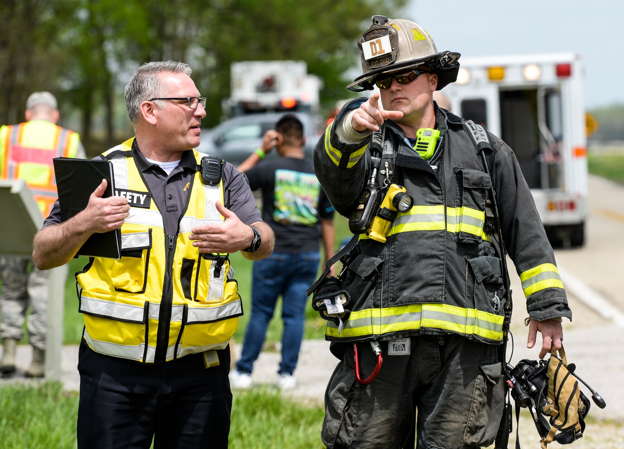 A firefighter from the 788th Civil Engineer Fire Department, talks with an individual from the 88th Air Base Wing safety office during a base exercise at Huffman Prairie Flying Field, Wright-Patterson Air Force Base, Ohio, May 2, 2019. (U.S. Air Force photo by Wesley Farnsworth)