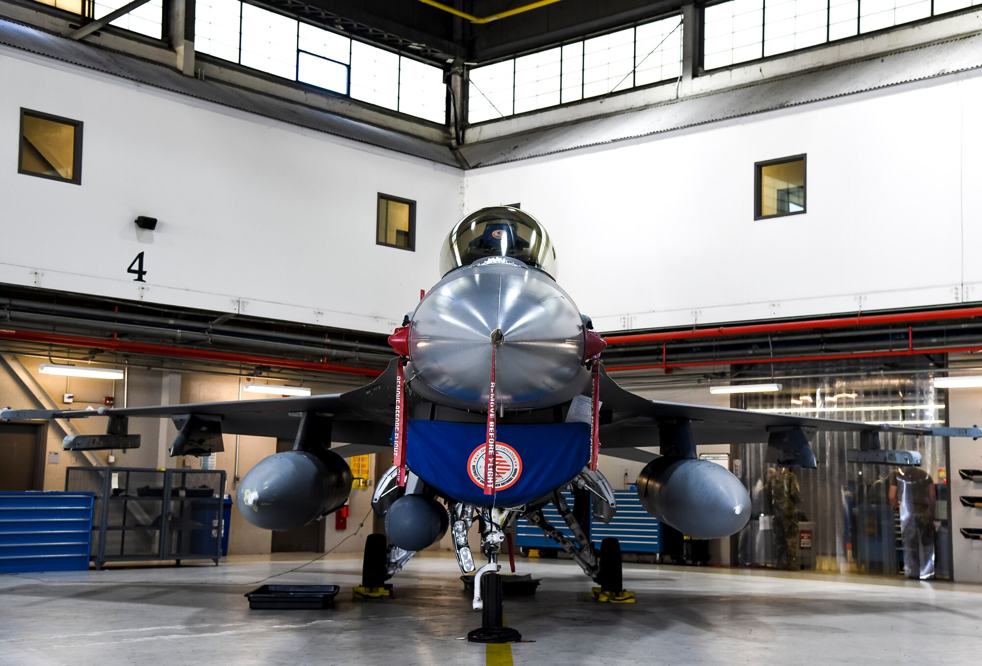 A F-16 Fighting Falcon from the 113th Wing, District of Columbia Air National Guard sits inside a maintenance hangar during the Dover Air Force Base honorary commander tour at Joint Base Andrews, Maryland, May 10, 2021. The 113th Wing defends the National Capital Region with 24/7 Aerospace Control Alert force and provides domestic operation capabilities in support of the District of Columbia. (U.S. Air Force photo by Airman 1st Class Stephani Barge)
