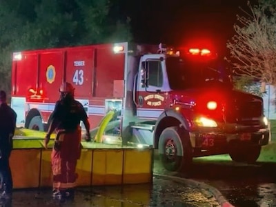 A Joint Base San Antonio Fire Emergency Services water tanker supplies water