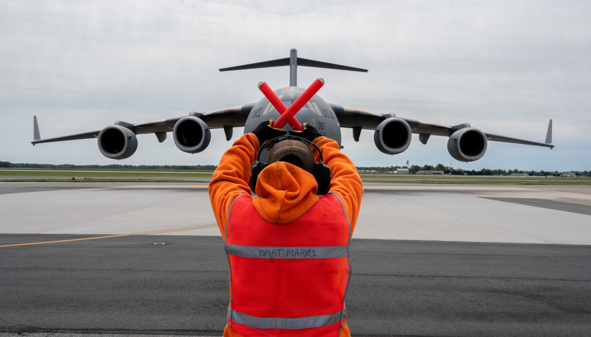 A member of the 436th Aircraft Maintenance Squadron transient alert marshals a North Carolina Air National Guard C-17 Globemaster III at Dover Air Force Base, Delaware, May 13, 2021. The C-17 carries a maximum of 170,900, allowing it to provide rapid airlift across the globe. (U.S. Air Force photo by Airman 1st Class Faith Schaefer)