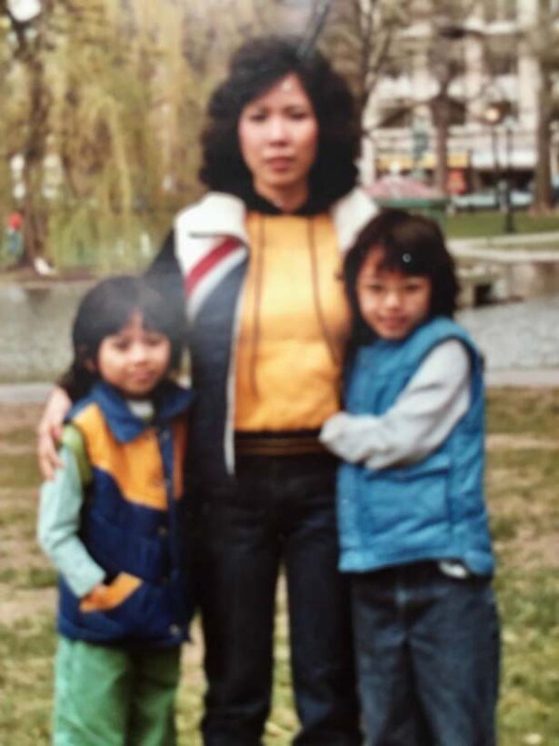 A woman and two children pose for a photo.