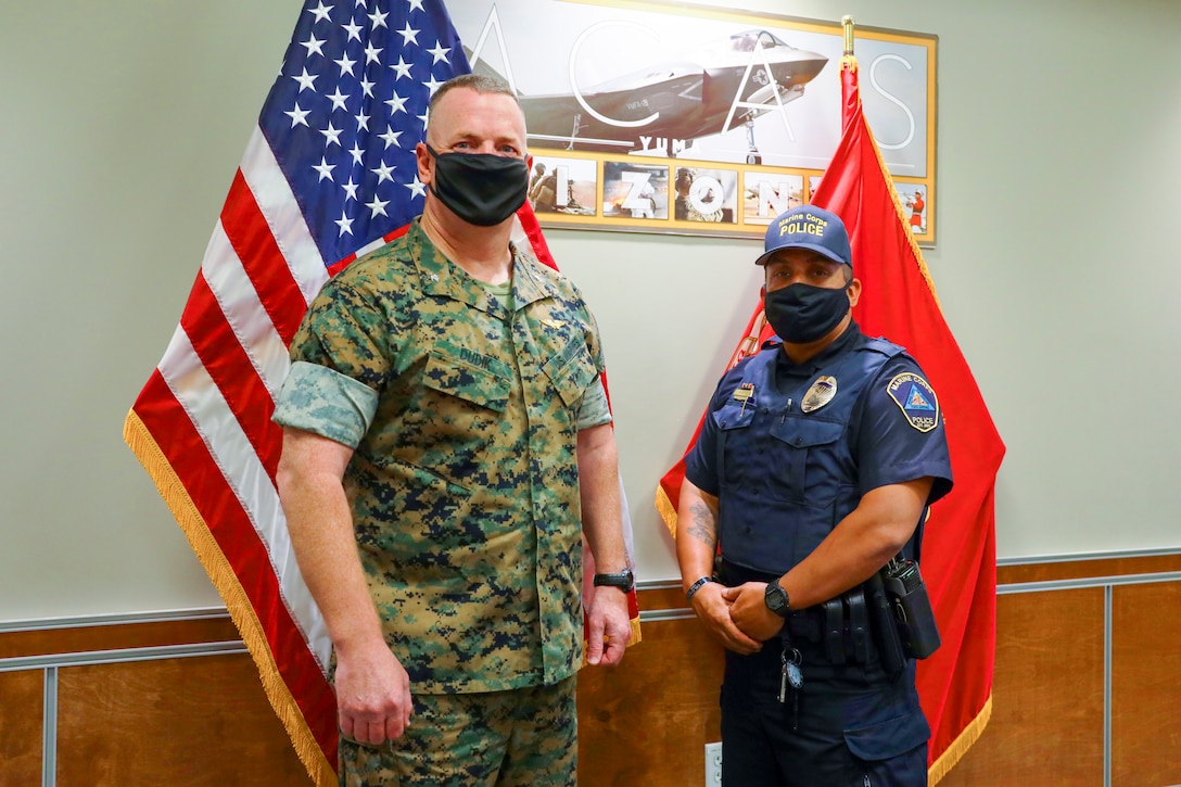 Col. Chuck Dudik and Military Police Officer Karl Bobbio pose for a picture after the award ceremony at Marine Corps Air Station (MCAS) Yuma, May 12, 2021.