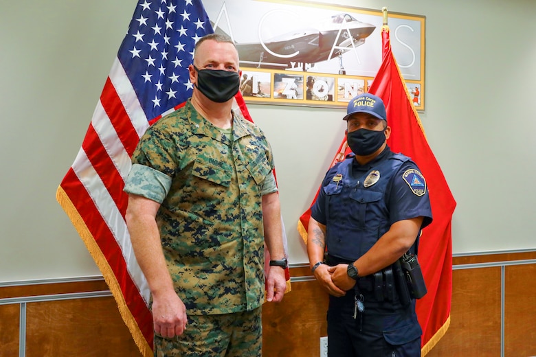 Col. Chuck Dudik and Military Police Officer Karl Bobbio pose for a picture after the award ceremony at Marine Corps Air Station (MCAS) Yuma, May 12, 2021. Officer Bobbio received this award for exemplifying high levels of professionalism, initiative and selfless dedication to the community of MCAS Yuma (U.S. Marine Corps photo by LCpl. Matthew Romonoyske-Bean)