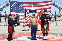 U.S. Marine Corps Master Sgt. Chris Medina stands at attention while two bagpipers play Anchors Away and the Marine Corps Hymn during a retirement ceremony at Marine Corps Air Station Yuma, April 30, 2021.  The ceremony honored MSgt Medina and the sacrifice he made while serving in the Marine Corps. (U.S. Marine Corps photo by LCpl. Matthew Romonoyske-Bean)