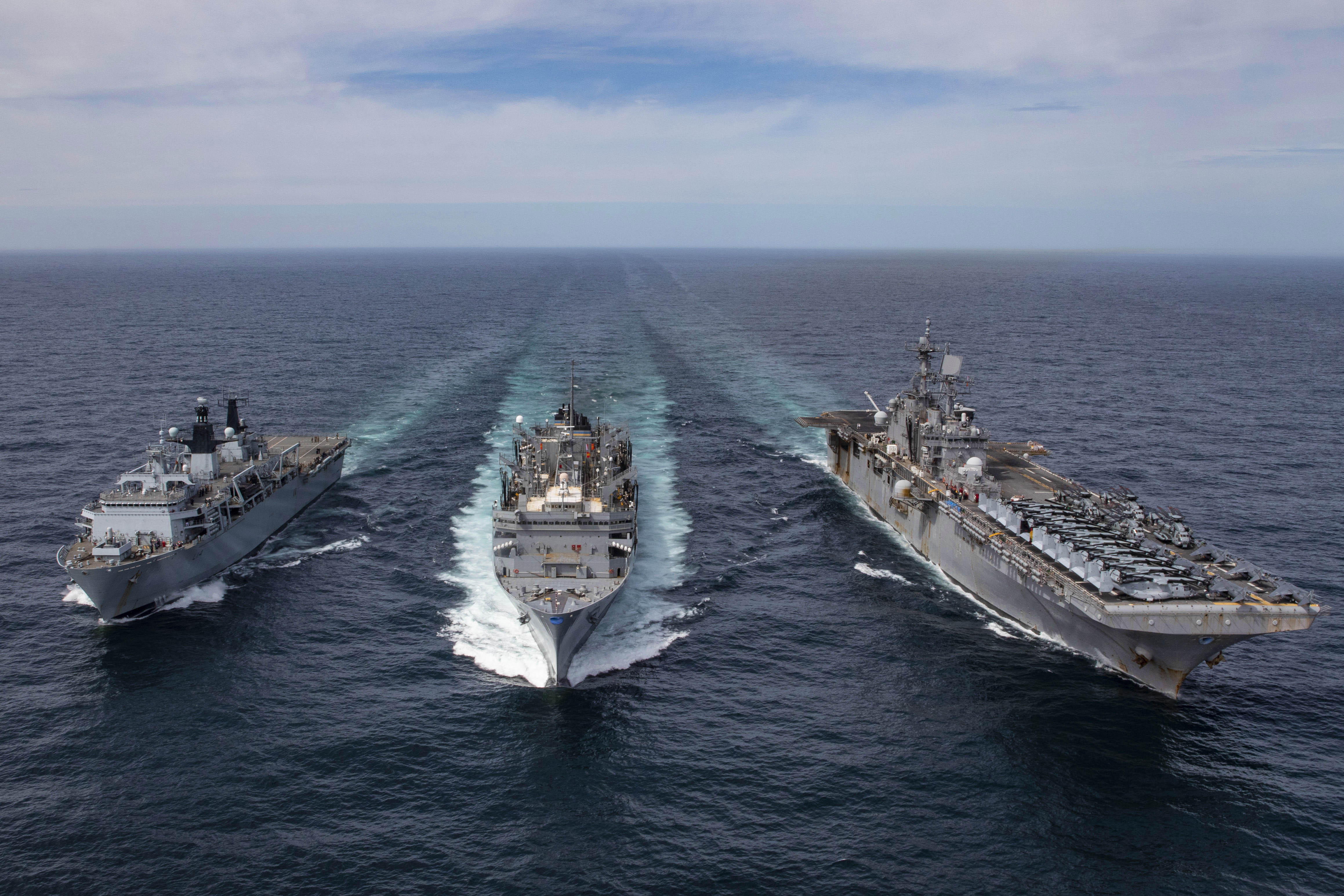 Three ships sail next to each other.