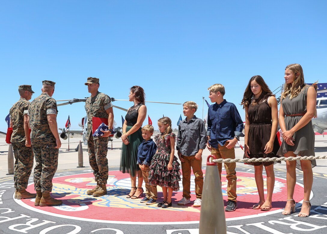 Lt. Col. Jim Paxton stands with his family during a retirement ceremony at  Marine Corps Air Station Yuma, April 30, 2021. The ceremony honored LtCol Paxton and the sacrifice he made while serving in the Marine Corps. (U.S. Marine Corps photo by Sgt. Jason Monty)