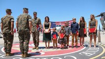 Lt. Col. Jim Paxton stands with his family during a retirement ceremony at  Marine Corps Air Station Yuma, April 30, 2021. The ceremony honored LtCol Paxton and the sacrifice he made while serving in the Marine Corps. (U.S. Marine Corps photo by Sgt. Jason Monty)