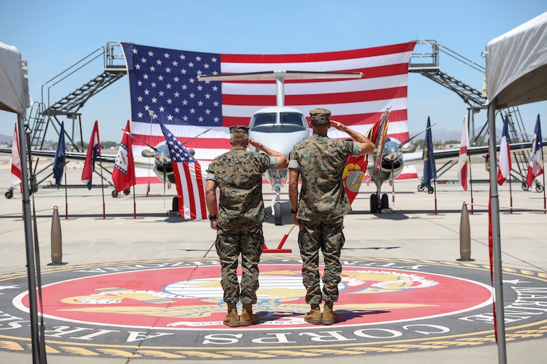 Lt. Col. Paxton (right)  and Col. Scott Koltick salute colors during a retirement ceremony at Marine Corps Air Station Yuma, April 30, 2021. The ceremony honored LtCol Paxton and the sacrifice he made while serving in the Marine Corps. (U.S. Marine Corps photo by Sgt. Jason Monty)