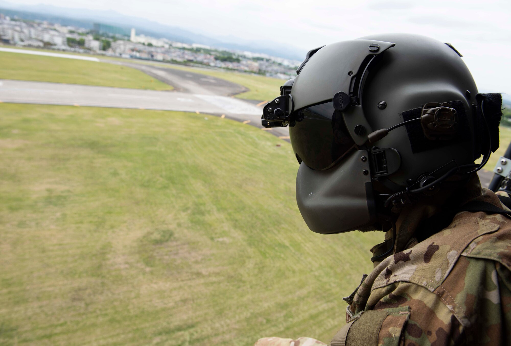 A U.S. Air Force Airman looks outside a UH-1N Iroquois helicopter