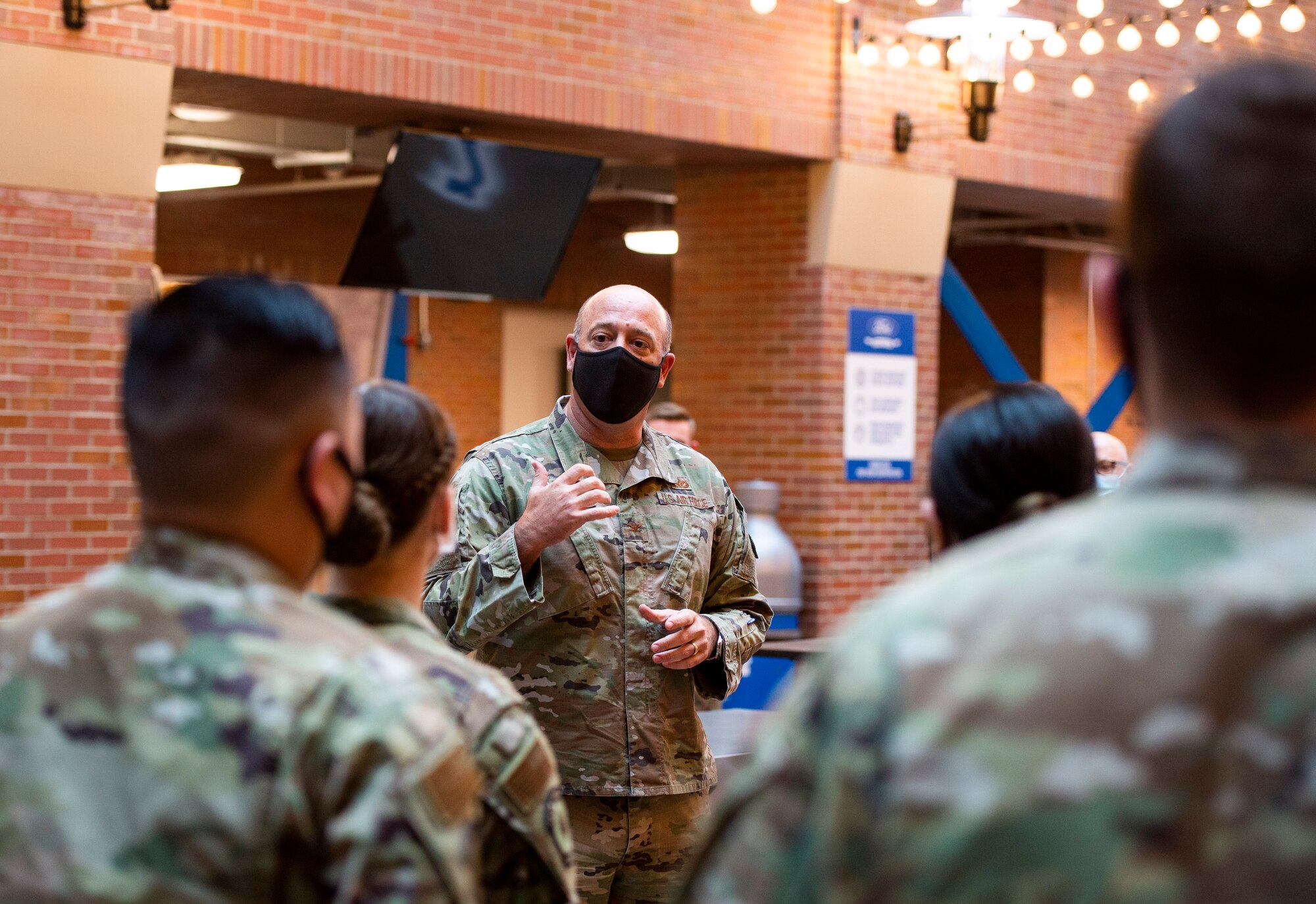 U.S. Air Force Col. Patrick Miller, 88th Air Base Wing commander, talks with Airmen from the 88th Medical Group, Wright-Patterson Air Force Base, Ohio, who are assigned to  at the federally-supported Community Vaccination Center (CVC) at Ford Field in Detroit, Michigan, May 3, 2021. Miller, along with the other members of the wing leadership, visited Detroit to witness first-hand how members of the 88th Medical Group are helping out at the Ford Field CVC which is designed to vaccinate up to 6,000 community members per day. U.S. Northern Command, through U.S. Army North, remains committed to providing continued, flexible Department of Defense support to the Federal Emergency Management Agency as part of the whole-of-government response to COVID-19. (U.S. Air Force photo by Wesley Farnsworth)