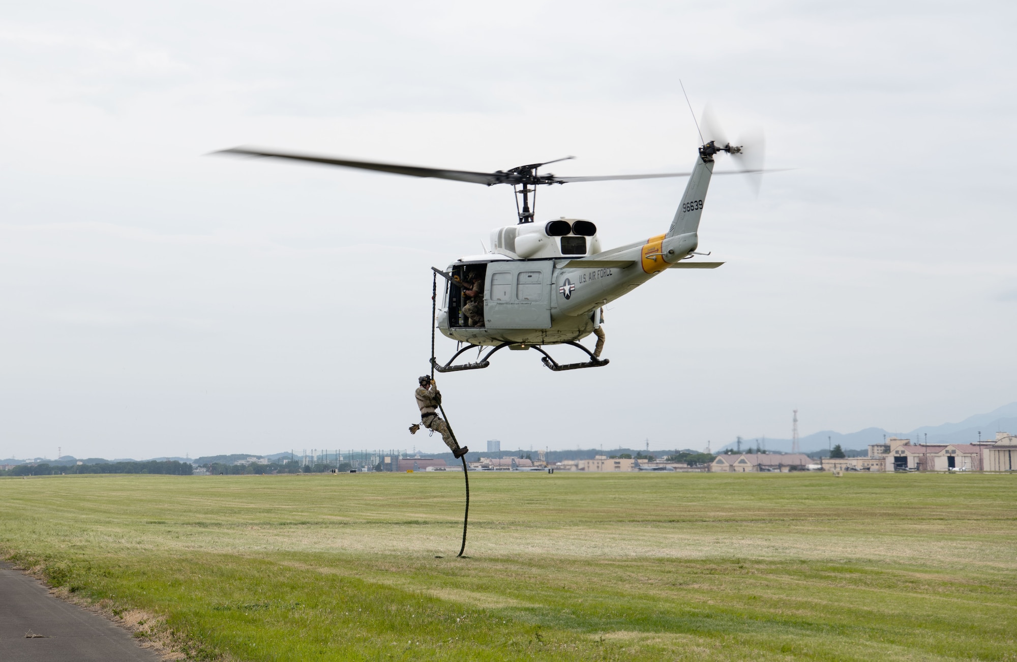 U.S. Airman fast ropes from a UH-1N Iroquois helicopter