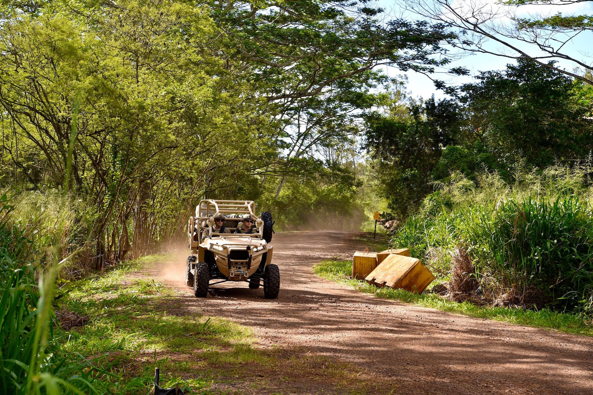 Air Force Office of Special Investigations Special Agent Cade Fraser and Tech. Sgt. Glenn Rinder, 25th Air Support Operations Squadron electrical power production craftsman, demonstrate the capabilities of the Polaris MRZR at Wheeler Army Airfield, Hawaii,  April 16, 2021. The OSI works with multiple teams in the Indo-Pacific to include the 25th ASOS. (US. Air Force photo by 2nd Lt. Benjamin Aronson)